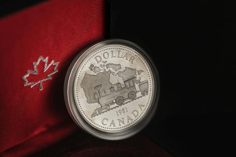 Detailed view of a 1981 Canadian silver dollar featuring a train design in an elegant case.
